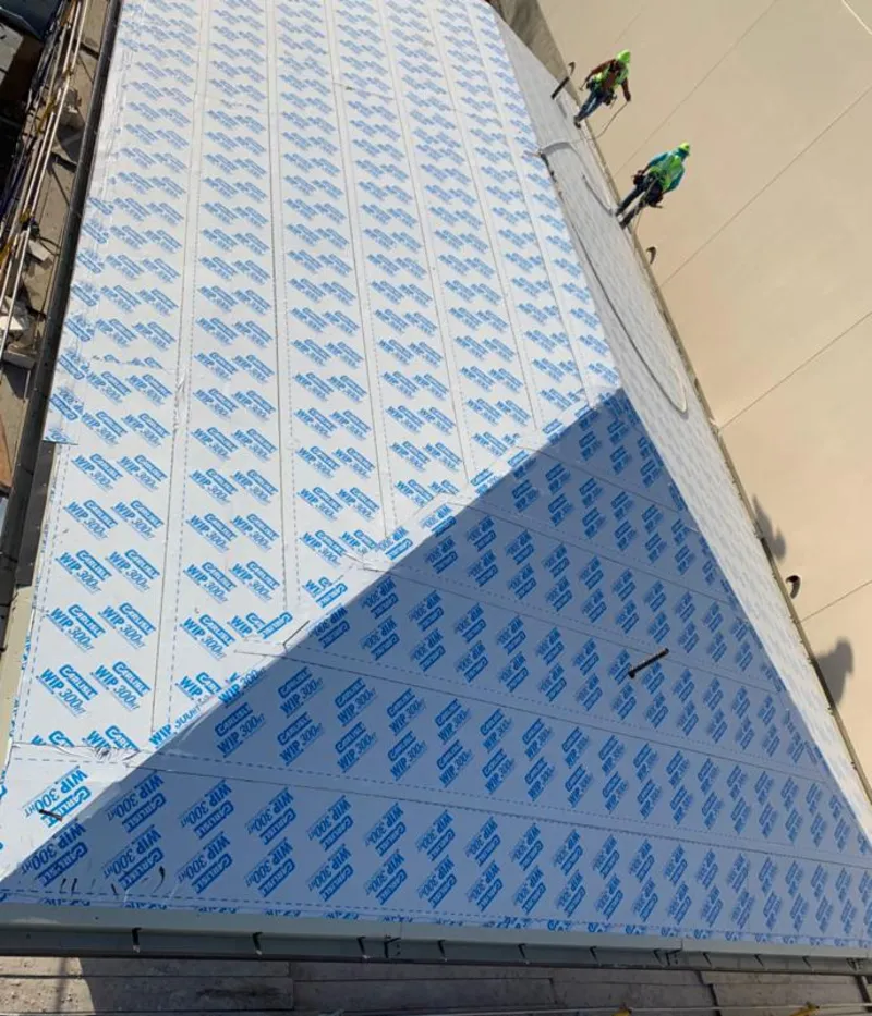 Professional roofers installing underlayment on a metal roof in Kathleen